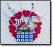 10" Patriotic Flag Waving Bear Wreath popping out of a heart box and streamers.  $20.  Click on image for enlarged view.